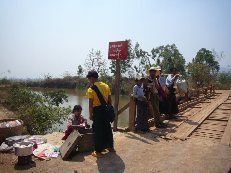 This woman sells the most delightful steamed doughnuts with a honey-like syrup inside - visible in the borma on the left hand side.